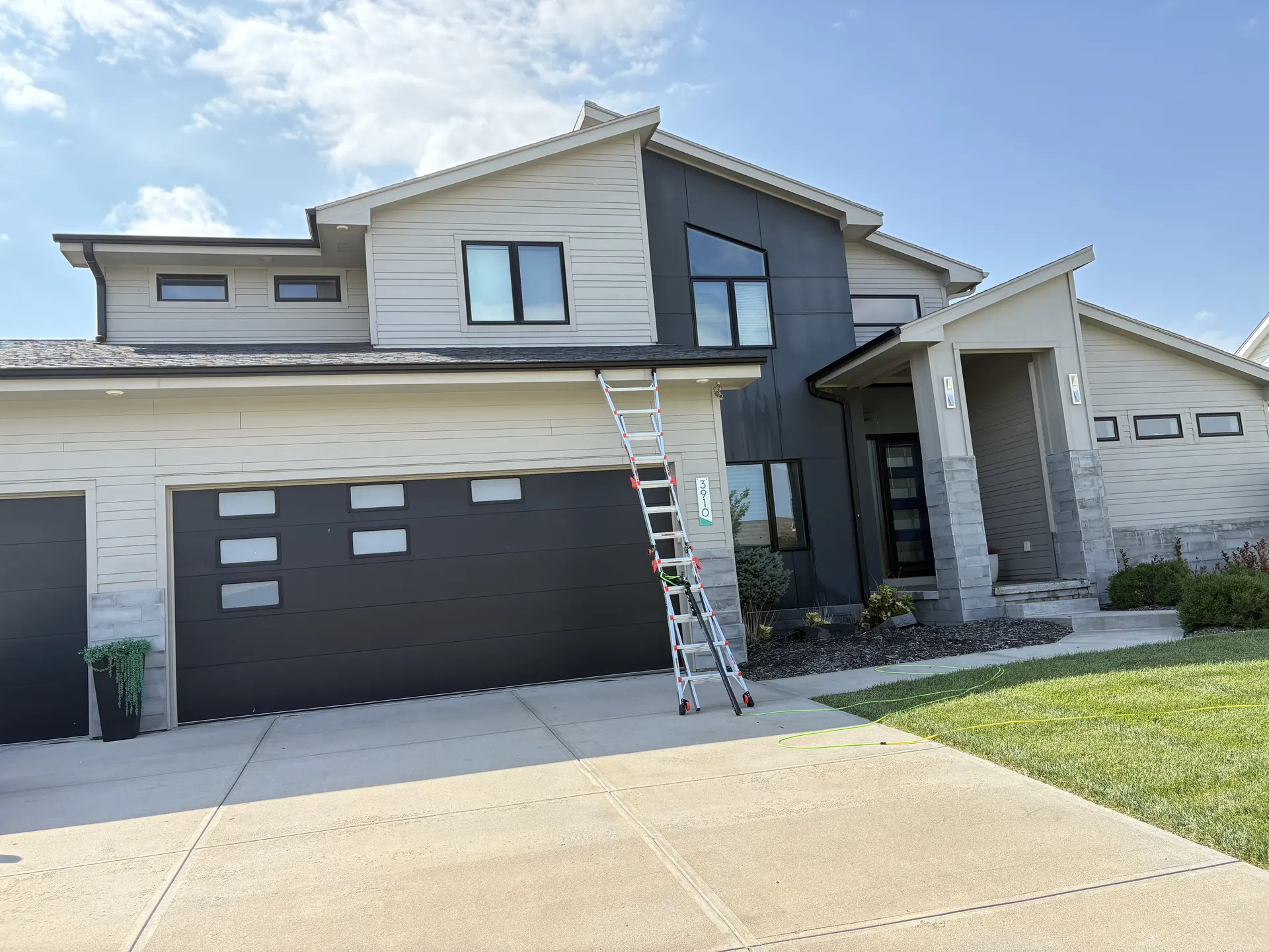 Clear glass after a full-house window cleaning on a two-story home in Omaha, Nebraska — with tracks and sills detailed