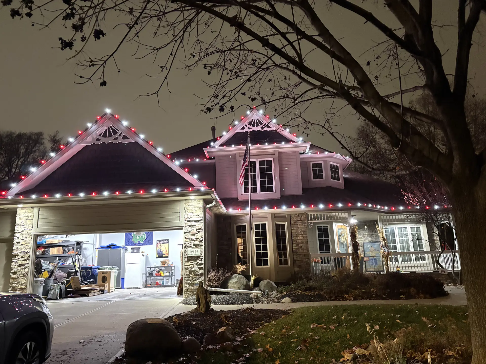 Classic red, green and white holiday lighting on a stone-front home
