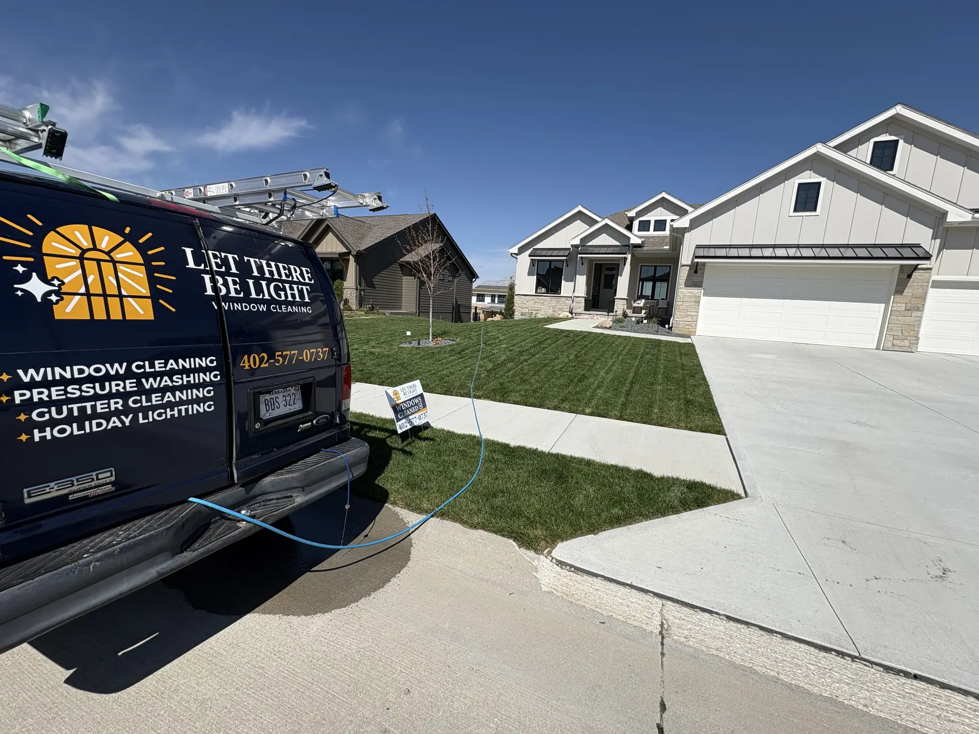 Close-up of the Let There Be Light Window Cleaning branding