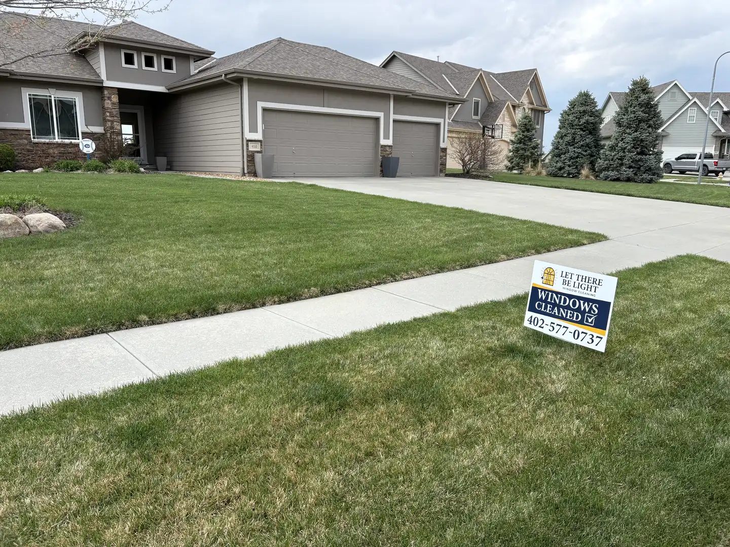 Streak-free exterior window cleaning result on a modern build in Omaha, Nebraska — with tracks and sills detailed