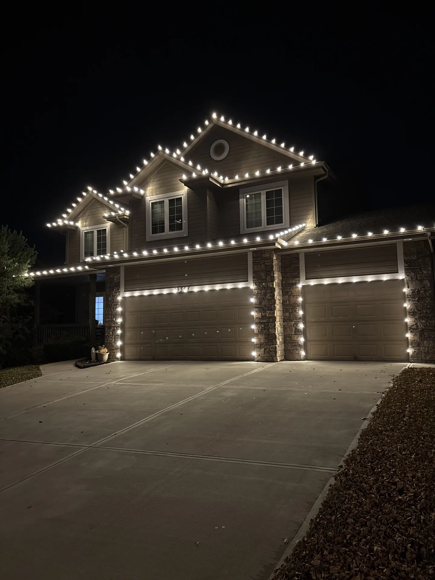 Holiday lights running cleanly along a steep roofline and gable